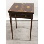 Edwardian mahogany and inlaid games table in Sheraton style, the bi-fold top enclosing a baize lined