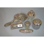 Four silver mounted dressing table items, including a hand mirror, together with a similar jar