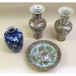 Pair of Canton enamel baluster form vases, decorated with panels of figures, and butterflies with