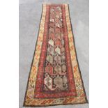Antique Kurdish runner with an all-over Boteh design, 336 x 84cm approximately (some wear)