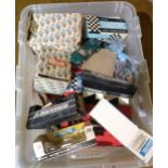Box containing a collection of vintage Scalextric, including various cars and track side