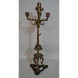 Antique style brass, three branch figural mounted candelabra, on tri-form base, 61cm high