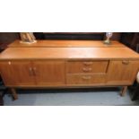 Mid 20th Century G Plan teak sideboard, having an arrangement of cupboards and drawers on shaped