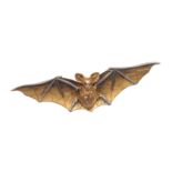 A GOLD BAT BROOCH.
