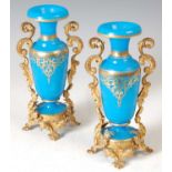 A pair of late 19th century French gilt metal mounted blue glass vases, with gilded details and