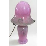 An early 20th century Monart style glass lamp, of mushroom form, the mottled pink and green body