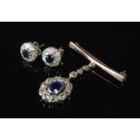 A white metal sapphire and diamond pendant brooch; together with a pair of white metal diamond and