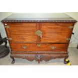 A George III Irish mahogany chest on stand, the top with carved rope twist edge, above two