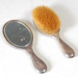 A Chester silver backed hand held dressing table mirror; together with corresponding hairbrush.