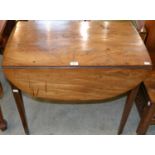 A 19th century mahogany Pembroke table, with two drop leaves and two drawers, one a faux drawer,