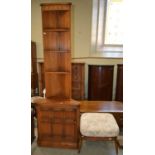 A mid-century Ercol corner cupboard, with four open shelves and cupboard door below, 198cm high x