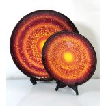 A graduated pair of Poole Pottery 'Sun and Moon Collection' chargers, numbered 247/1000 and 325/