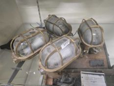 Four brass cased industrial style wall lights