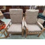 A pair of Ercol beech framed upholstered easy chairs