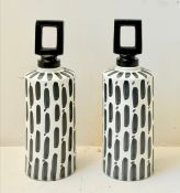 PAIR OF BLACK AND WHITE CERAMIC LIDDED JARS.