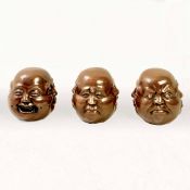 SET OF THREE FOUR SIDED BRONZE HEADS.