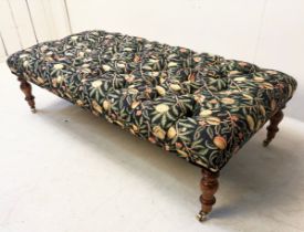 HEARTH STOOL WITH FRUIT DESIGN DEEP BUTTONED UHOLSTERY ON TRUNED SUPPORTS.