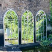 SET OF THREE ARCHITECTURAL GARDEN MIRRORS WITH ARCHED METAL FRAMES.