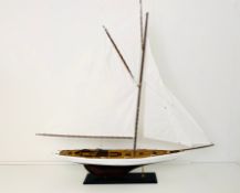 MODEL SAILING BOAT ON STAND.