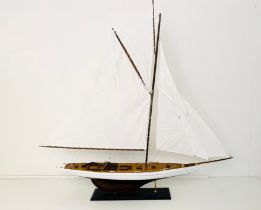 MODEL SAILING BOAT ON STAND.