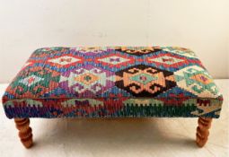 HEARTH STOOL WITH KILIM UPHOLSTERY ON TURNED SUPPORTS.