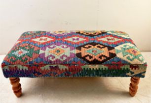 HEARTH STOOL WITH KILIM UPHOLSTERY ON TURNED SUPPORTS.