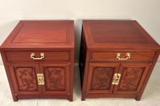 PAIR OF CHINESE TEAK BEDSIDE CABINETS WITH CARVED PANEL DOORS BY GEORGE ZEE.