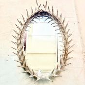 WALL MIRROR WITH A SILVERED FAUX ANTLER FRAME.