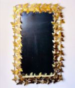 WALL MIRROR WITH GILT METAL BUTTERFLY FRAME.