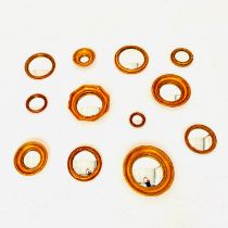 SET OF TWELVE CONVEX MIRRORS WITH GILT FRAMES.