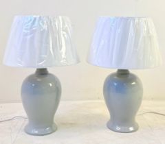 PAIR OF GREY CERAMIC TABLE LAMPS WITH WHITE SHADES.