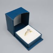 A 9CT YELLOW GOLD DIAMOND SOLITAIRE RING.