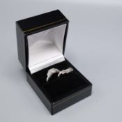 A PAIR OF PLATINUM 'EITHER SIDE' RINGS.