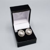 A PAIR OF SILVER AND DIAMOND STUD EARRINGS.