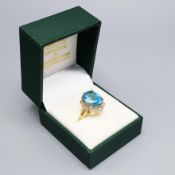 A 9CT YELLOW GOLD TOPAZ AND DIAMOND DRESS RING.