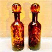 PAIR OF MURANO STYLE TORTOISE SHELL GLASS DECANTER BOTTLES.