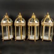 A SET OF FOUR REGENCY STYLE GILT METAL AND GLASS LANTERNS.