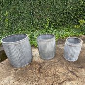 GRADUATED SET OF THREE RIBBED ZINC PLANTERS.