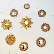 SET OF NINE SUNBURST GILT FRAMED CONVEX MIRRORS.