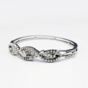 AN 18CT WHITE GOLD DIAMOND BANGLE.