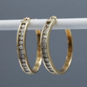A PAIR OF 10CT GOLD DIAMOND SET HOOP EARRINGS.