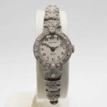 A CARTIER ART DECO PLATINUM AND DIAMOND SET COCKTAIL WATCH.