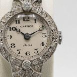 A CARTIER ART DECO PLATINUM AND DIAMOND SET COCKTAIL WATCH.