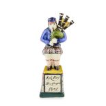 A RARE PEARLWARE POTTERY FIGURE MODELLED AS 'ROB ROY MACGREGOR'S PIPER'