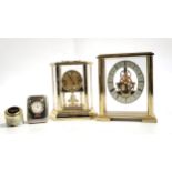 A collection of four clocks, two mantle and two desk clocks.