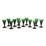 A set of twelve Georgian Bristol green glass wine glasses with conical bowls and knopped stems