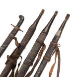 Three 19th century Omani Kattara swords with leather bound hilts, and leather scabbards with