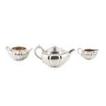 A William IV silver three piece tea service, of compressed and panelled design, the teapot with