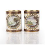 A pair of 18th century Worcester Dalhousie type porcelain mugs, painted with landscape vignettes and