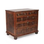 A William and Mary walnut and oyster veneered chest of two short and three long drawers with brass